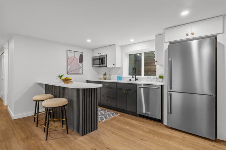 Lower-level kitchen with dark cabinetry