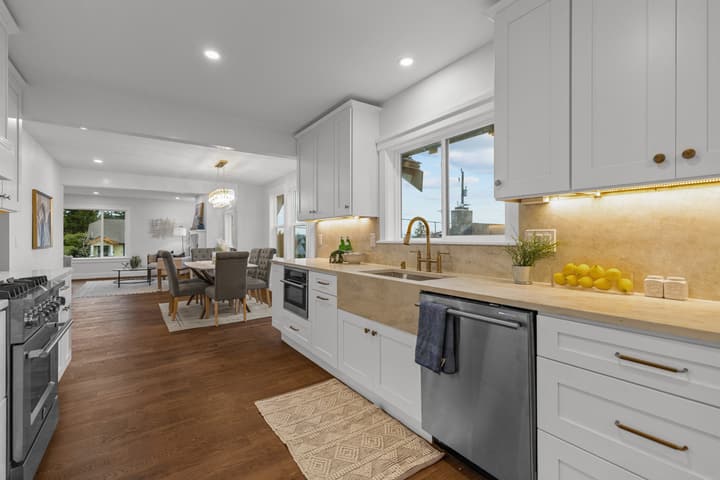 White shaker kitchen with brass pendants