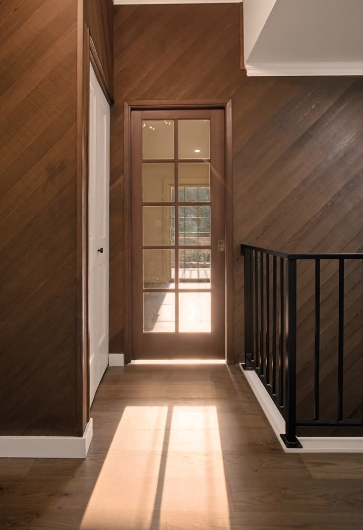 Arched entry with wood accent wall
