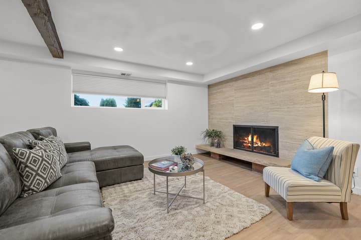 Finished basement lounge with fireplace