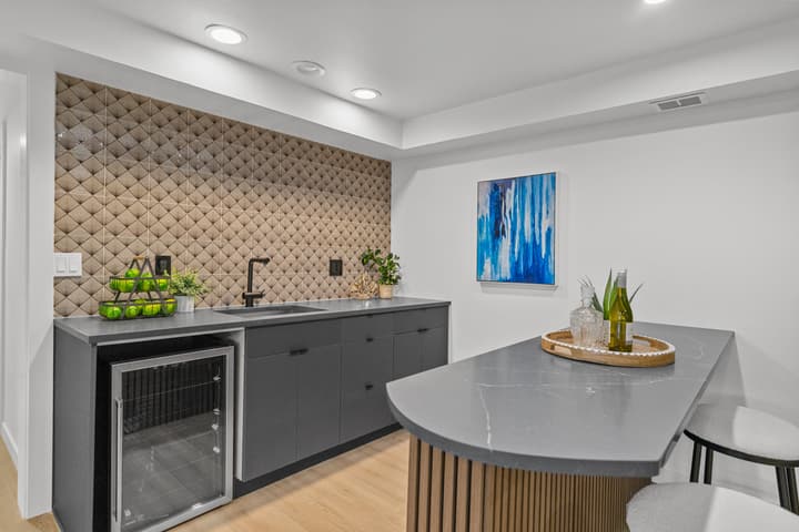 Basement wet bar with beverage fridge