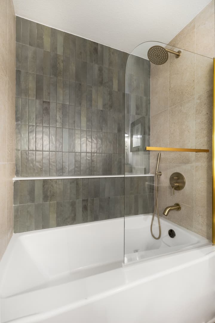 Tiled bathroom with brass fixtures