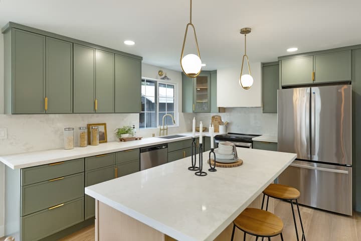 Sage green kitchen with brass hardware