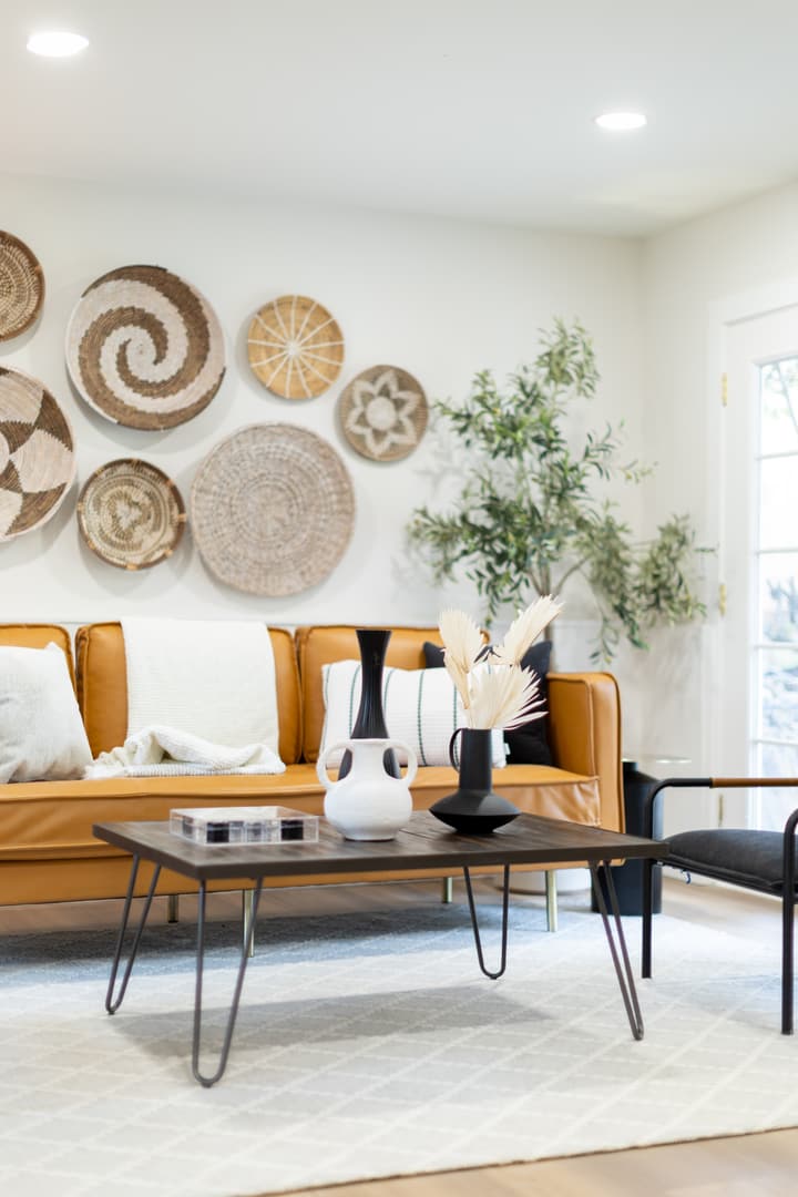 Living room with woven wall art and green accents