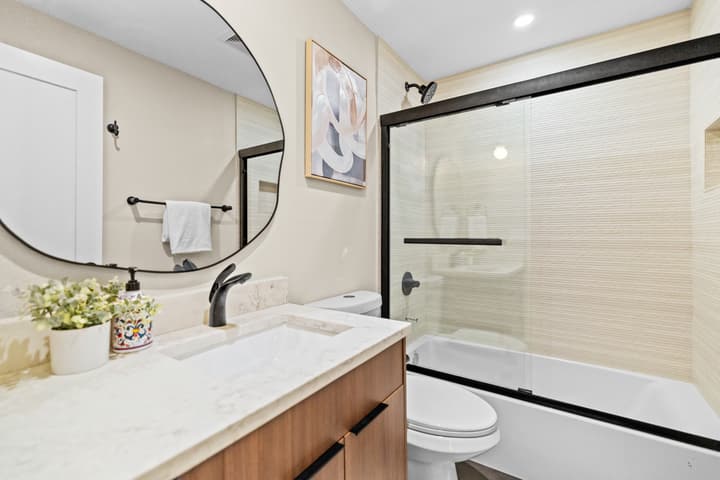 Bathroom vanity with black frame mirror