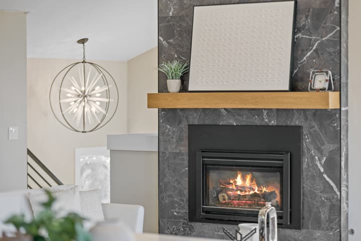 Marble-look fireplace with wood mantel