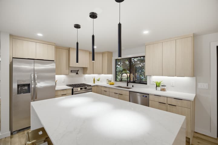 White kitchen with long quartz island