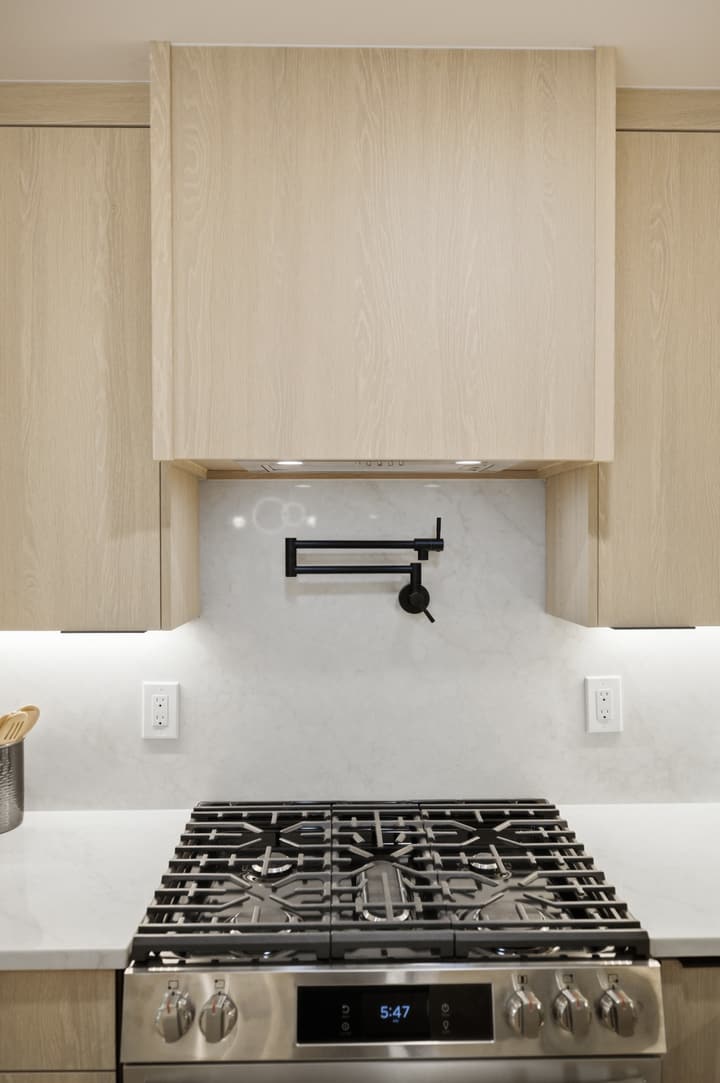 Range wall with pot filler and wood cabinets