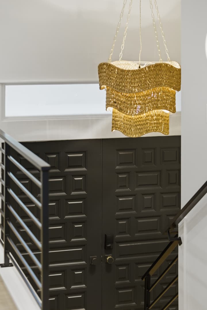 Stair with black metal railing and pendant