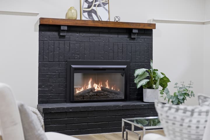 Living room with black brick fireplace