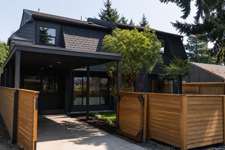 Dark modern exterior with cedar fence