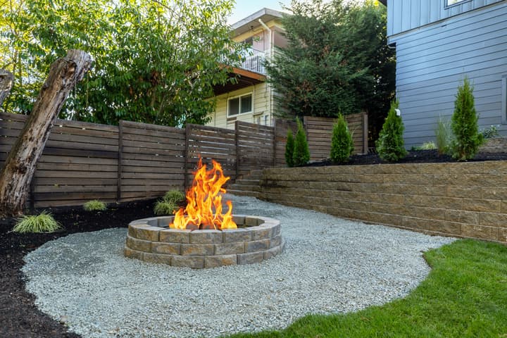 Backyard fire pit with gravel seating area