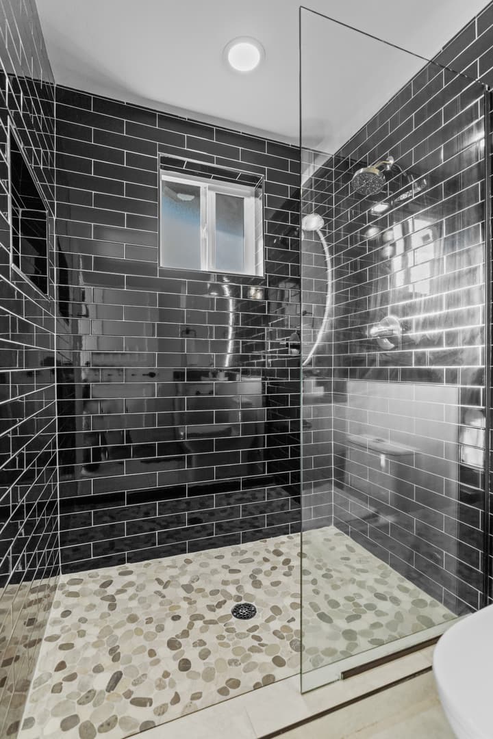 Bathroom with glossy black subway tile